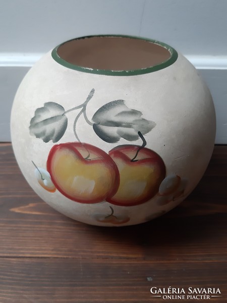 A spherical ceramic vase richly decorated with flower and fruit motifs
