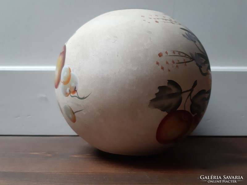 A spherical ceramic vase richly decorated with flower and fruit motifs