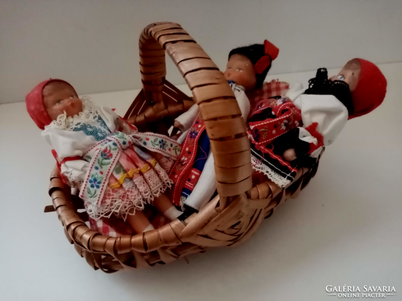 3- Pieces of a small rubber doll in old folk clothes in a small wicker basket for sale together