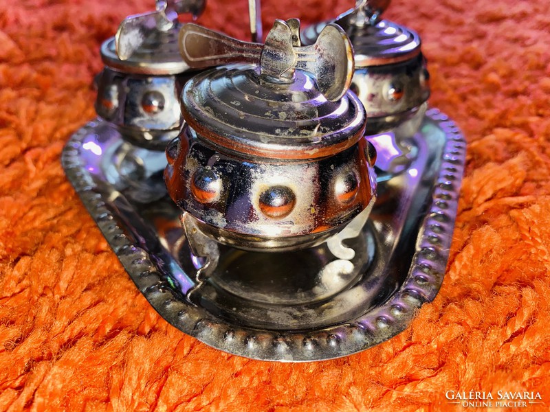 A special set of beautiful nickel-plated spice holders with small spoons