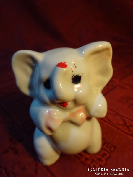 German porcelain elephant with pink bow, height 6.5 cm. He has!