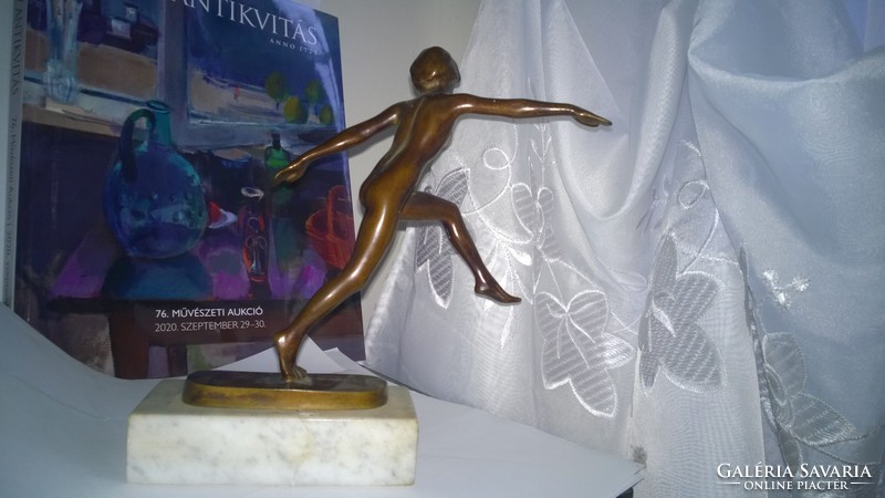 Bronze gymnast nude on marble sole. Statue