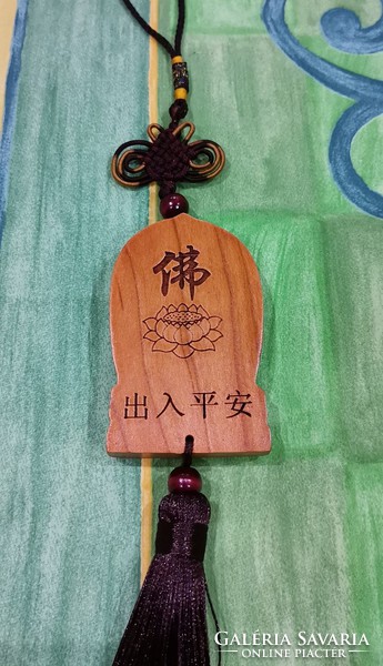 Real room. Rosewood pendant, amulet, meditating Shakyamuni Buddha