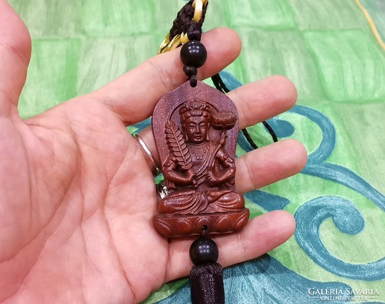 Real room. Rosewood pendant, amulet, akasagarbha bodhisattva