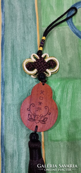 Real room. Rosewood pendant, amulet, laughing Maitreya Buddha