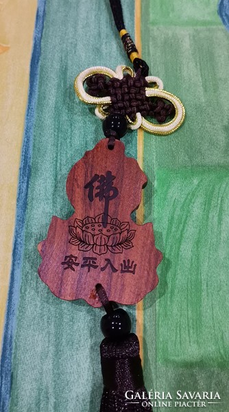 Real room. Rosewood pendant, amulet, lotus