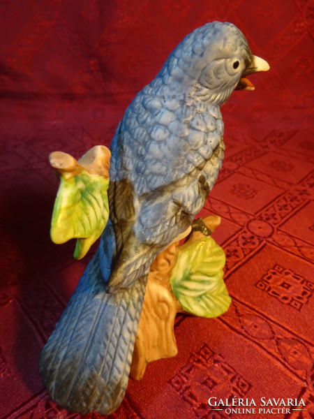 Porcelain figurine with a blue feathered bird on a tree branch, height 12.5 cm. He has!