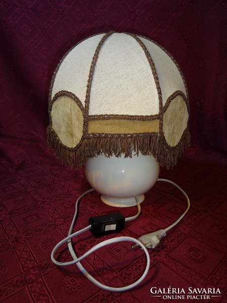 Spanish porcelain bedside lamp with linen and fringed lamp. He has!