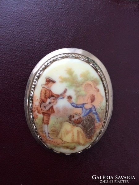 Antique porcelain metal brooch with a romantic scene