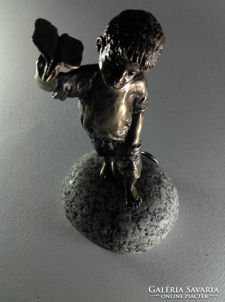 Bronze statue of little boy flying