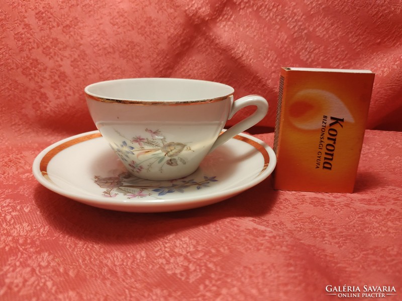 Tiny porcelain coffee cup with saucer