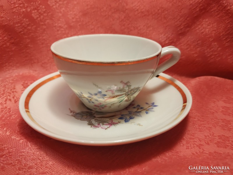 Tiny porcelain coffee cup with saucer
