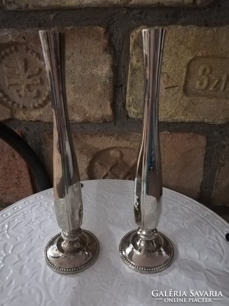 A pair of decorative vases for one flower each
