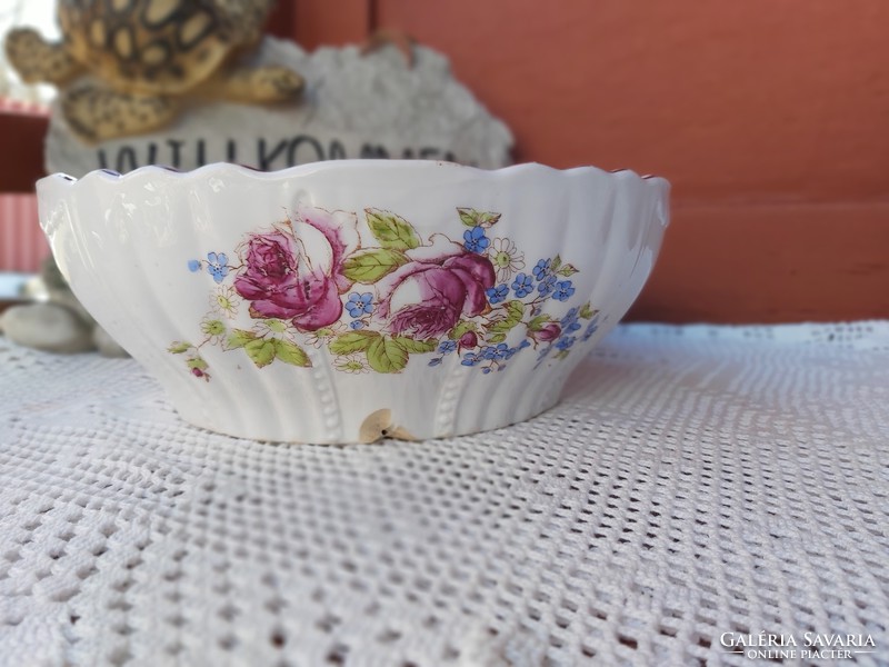 A porcelain bowl with a beautiful pattern of flowers with pink scones, rustic decoration