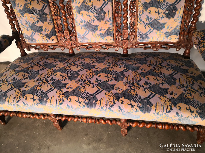 Old antique, richly carved renaissance style sofa