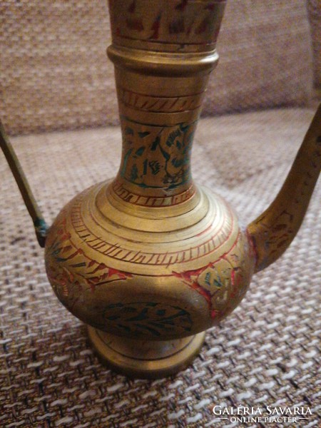 Small copper decanter with colorful, engraved patterns