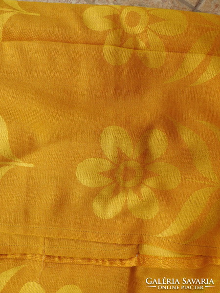 A pair of blackout curtains with a golden flower pattern