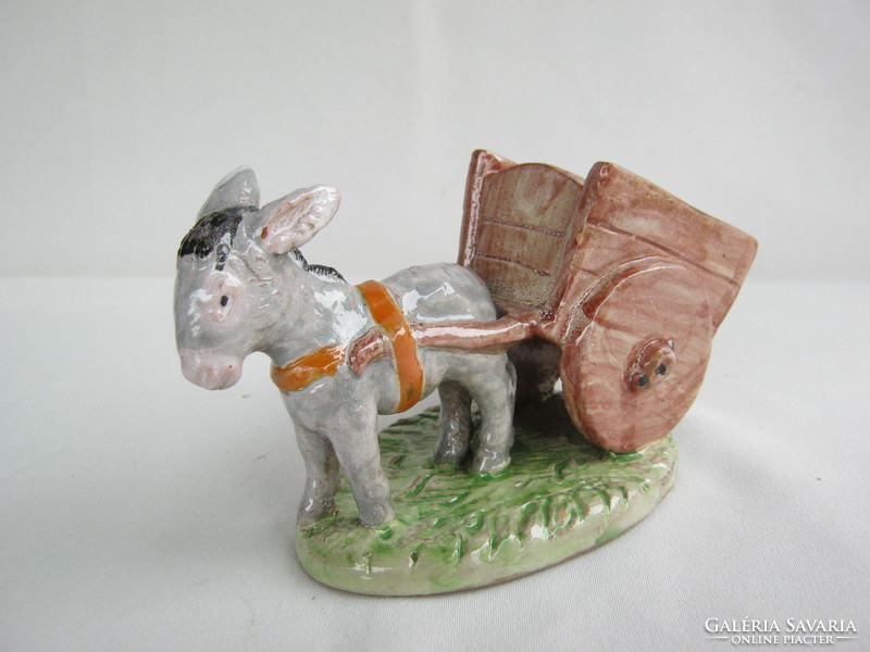 Donkey pulling a sweaty ceramic cord