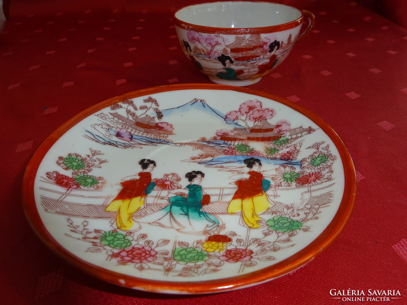 Japanese porcelain teacup + placemat with brown border. He has!