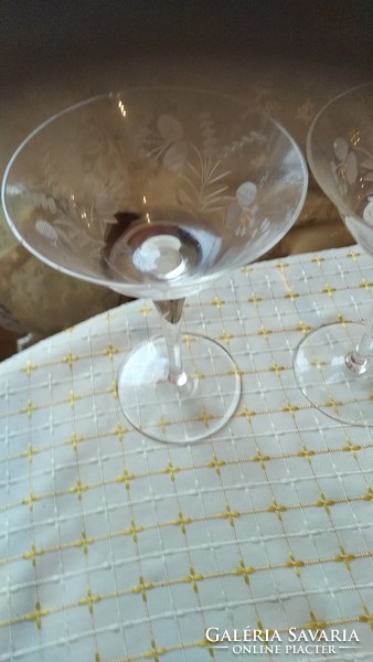 A pair of antique crystal glasses with a small charm