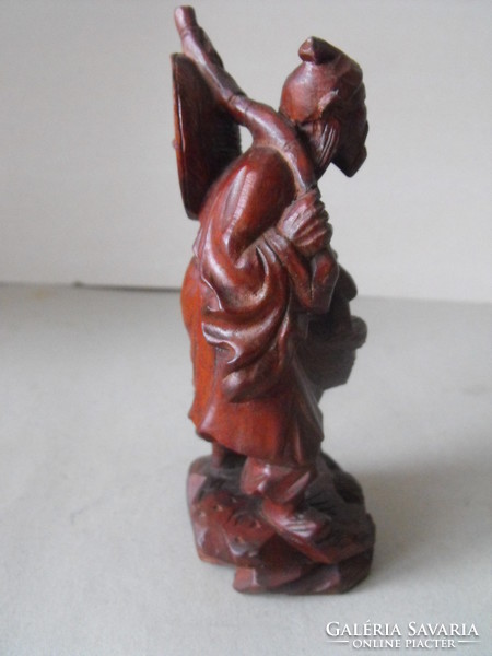 Oriental wanderer, wood carving