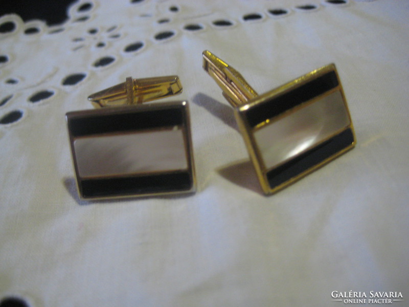 Two pairs of cufflinks and a tie clip