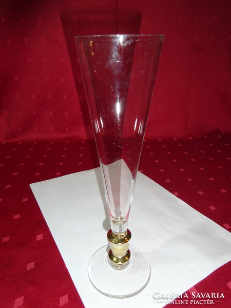 Funnel-shaped champagne glass with gold decoration. Its height is 23.5 cm. He has!