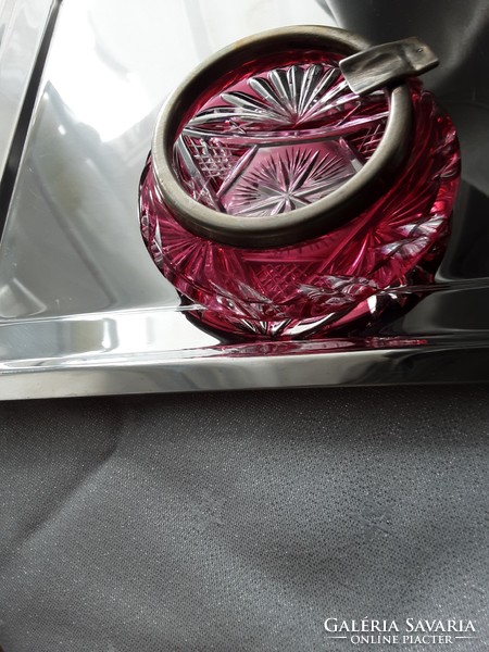 An antique crystal ashtray in ruby red with an old, marked silver rim
