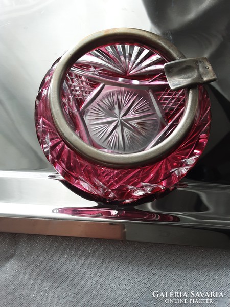 An antique crystal ashtray in ruby red with an old, marked silver rim