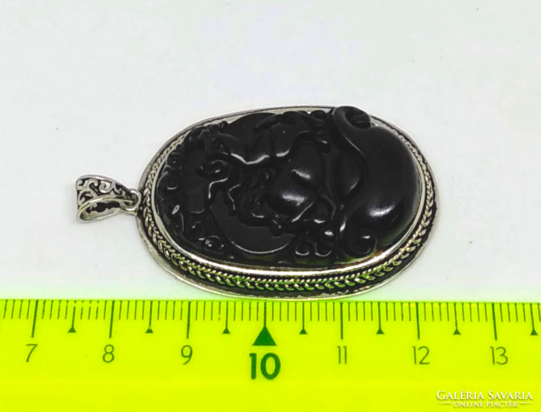 Equestrian carved black stone pendant in a silver-plated socket