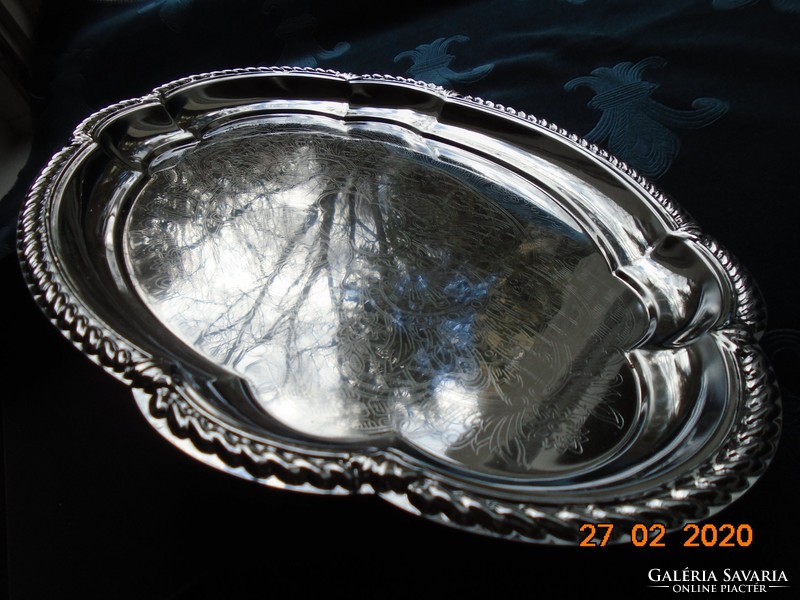 Chrome-nickel metal tray with a baroque shape, embossed rim, and chiseled antique patterns