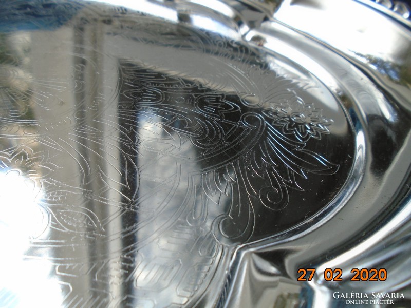 Chrome-nickel metal tray with a baroque shape, embossed rim, and chiseled antique patterns