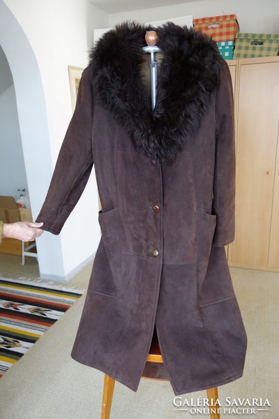 A very beautiful brown women's fur coat - sheepskin - is back in fashion