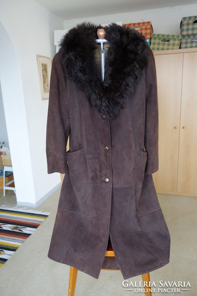 A very beautiful brown women's fur coat - sheepskin - is back in fashion