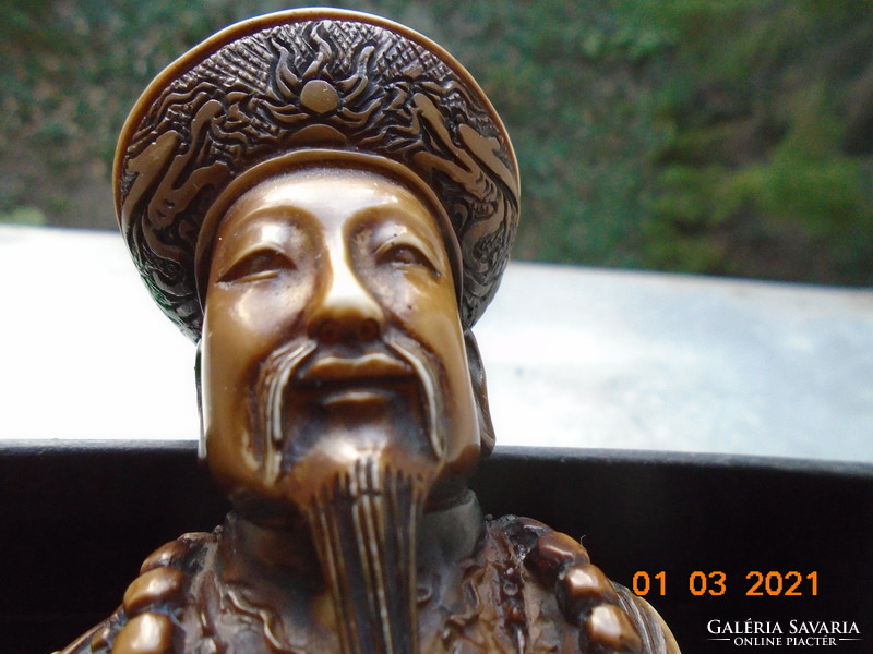 The Chinese emperor with a decorative sword is a handmade statue