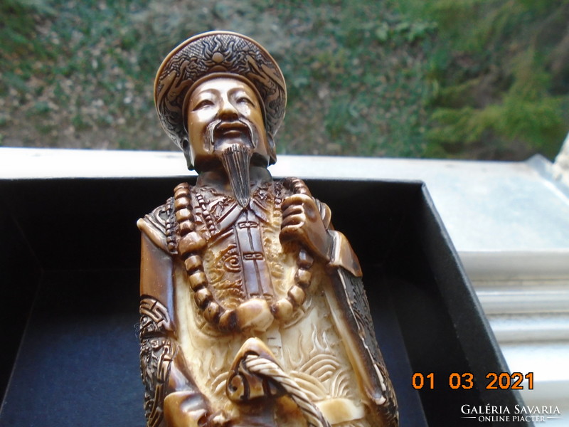 The Chinese emperor with a decorative sword is a handmade statue