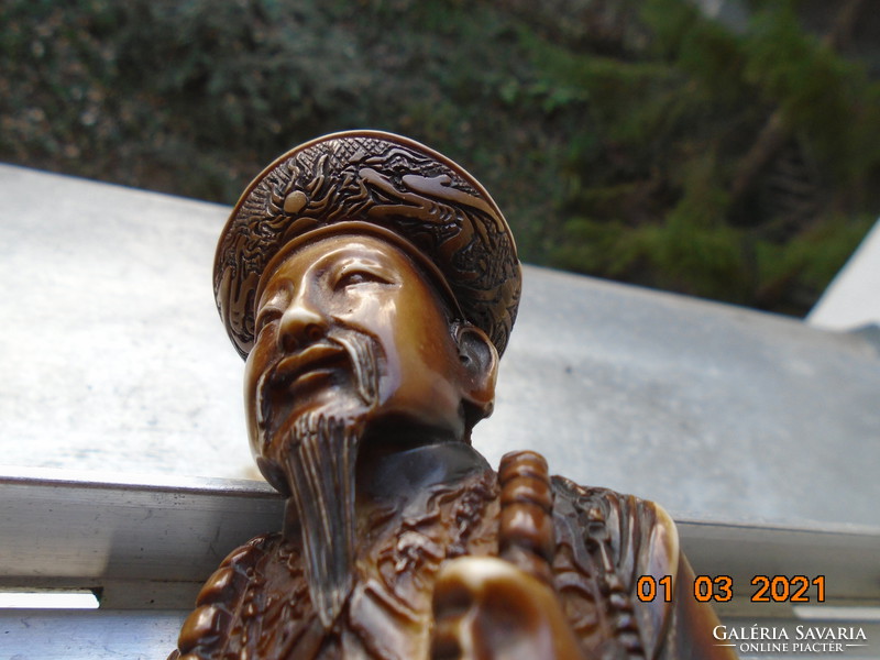 The Chinese emperor with a decorative sword is a handmade statue