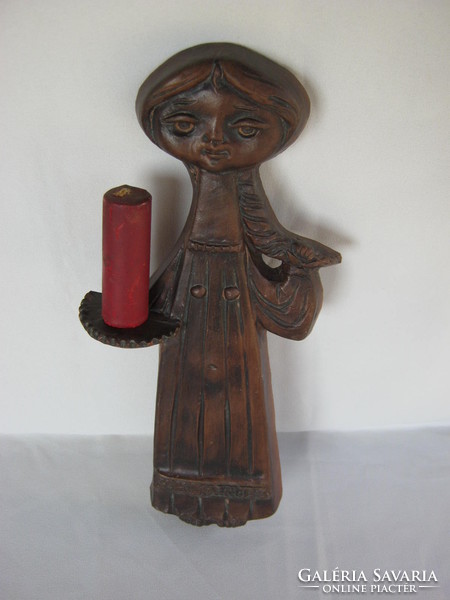 Girl with candlestick on ceramic wall ornament