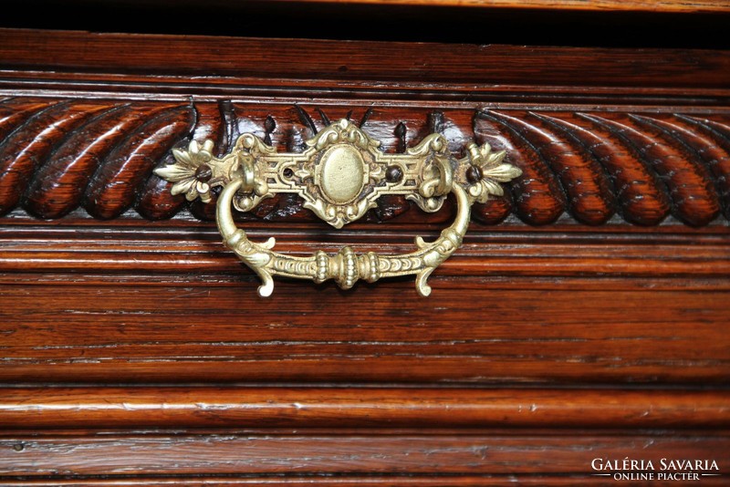 Tin German, richly carved chest of drawers made of oak