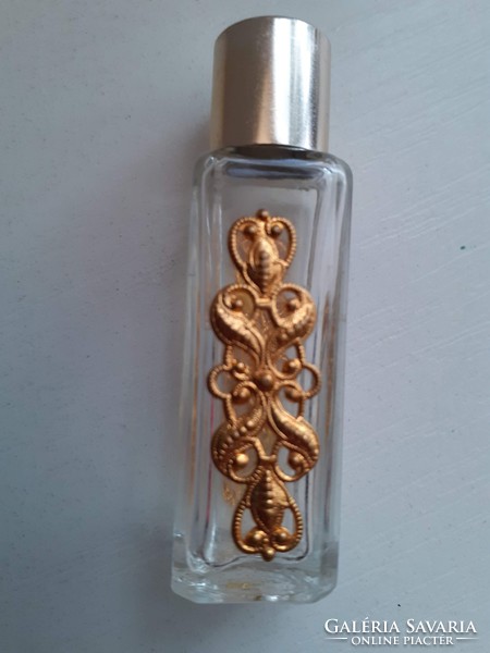 A white perfume bottle with a pattern, decorated with a gilded patterned plate on both sides, in good condition