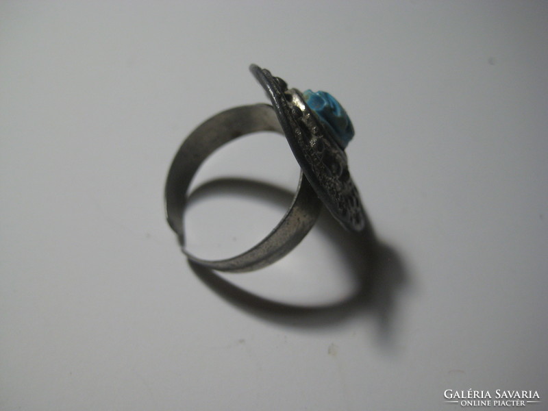 In the middle of an antique ring is a scarabeus beetle carved from a mineral