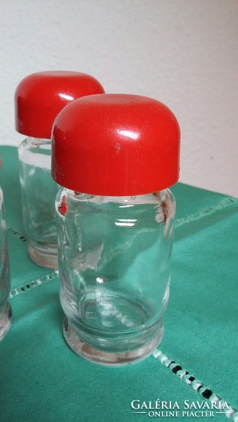 Retro glass spice racks in floral plastic holder