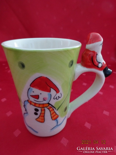Christmas porcelain mug, snowman and Christmas tree on the side, Santa Claus sitting on his ear. He has!