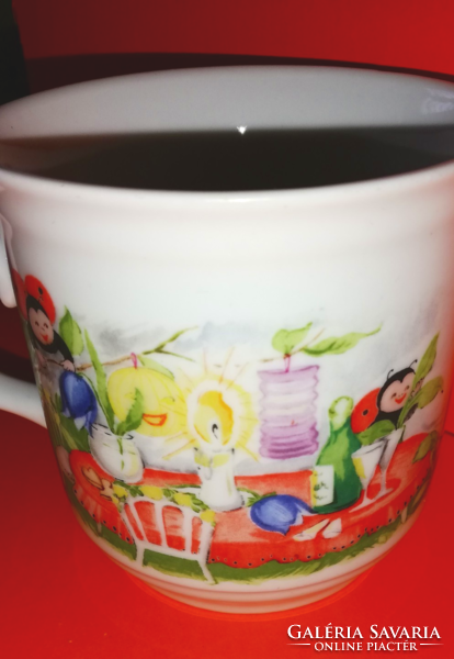 A beautiful cocoa mug with a fairy-tale pattern and a ladybug