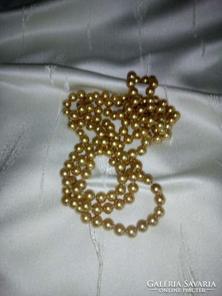 A long string of golden brown pearls