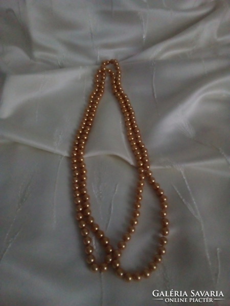 A long string of golden brown pearls