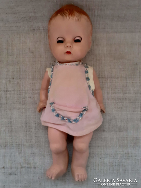 Old marked sleeping baby with structure on back in own little dress