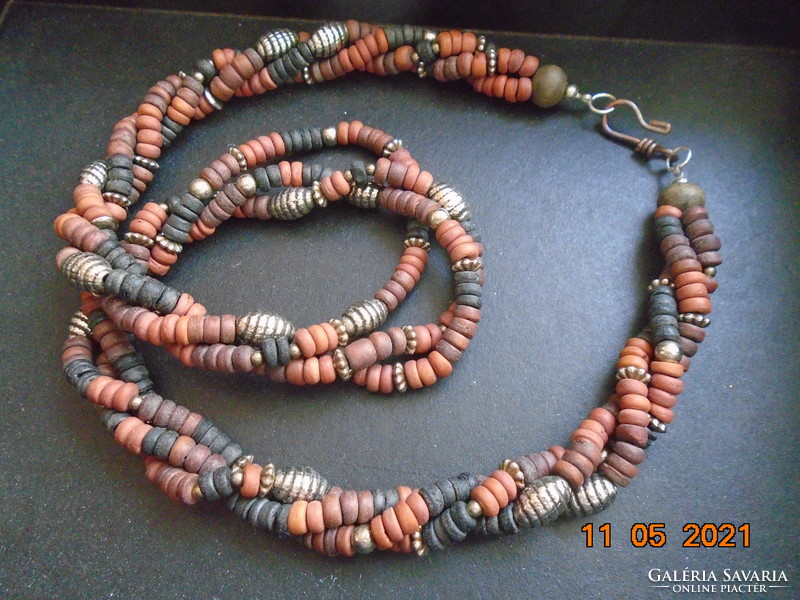 Tribal three-row twisted necklaces made of smaller multi-colored sandalwood and larger silver-colored metal beads