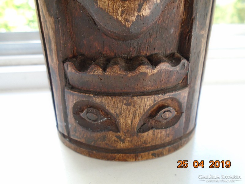 Totem carved pole with magical face