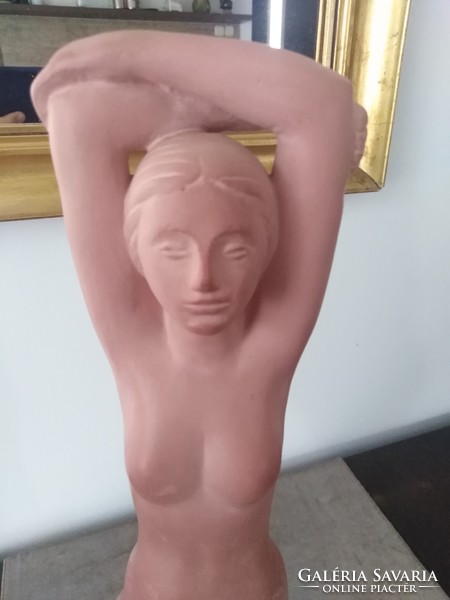 Spherical ceramic sculpture of a female nude